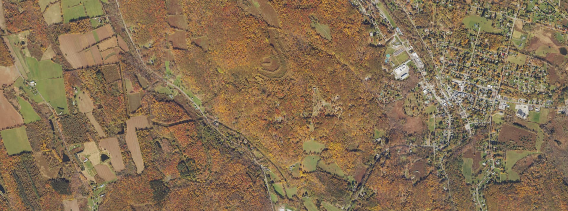 Aerial survey view over Millerton, NY, showing the village grid, Route 22 and the Taconic hills beyond