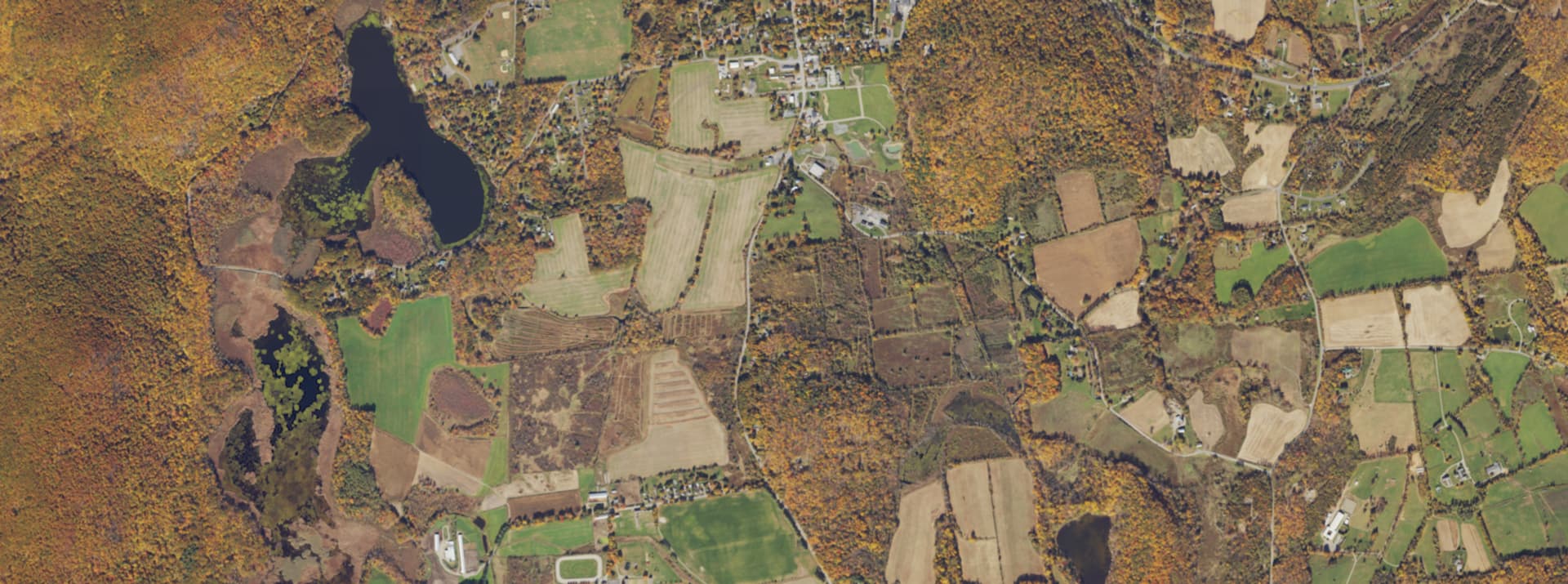 Aerial survey view over Pine Plains, NY, showing the village centre, surrounding farmland and tree cover